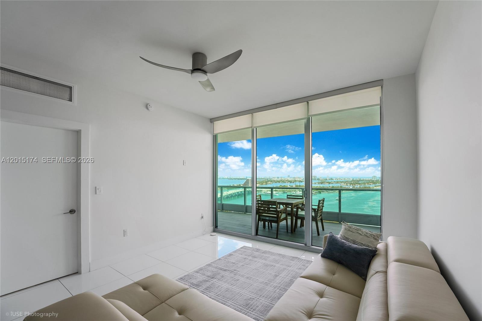 900 Biscayne Boulevard, Unit 3407 Miami, FL 33132 - Photo 7 of 15 a living room with furniture and a floor to ceiling window