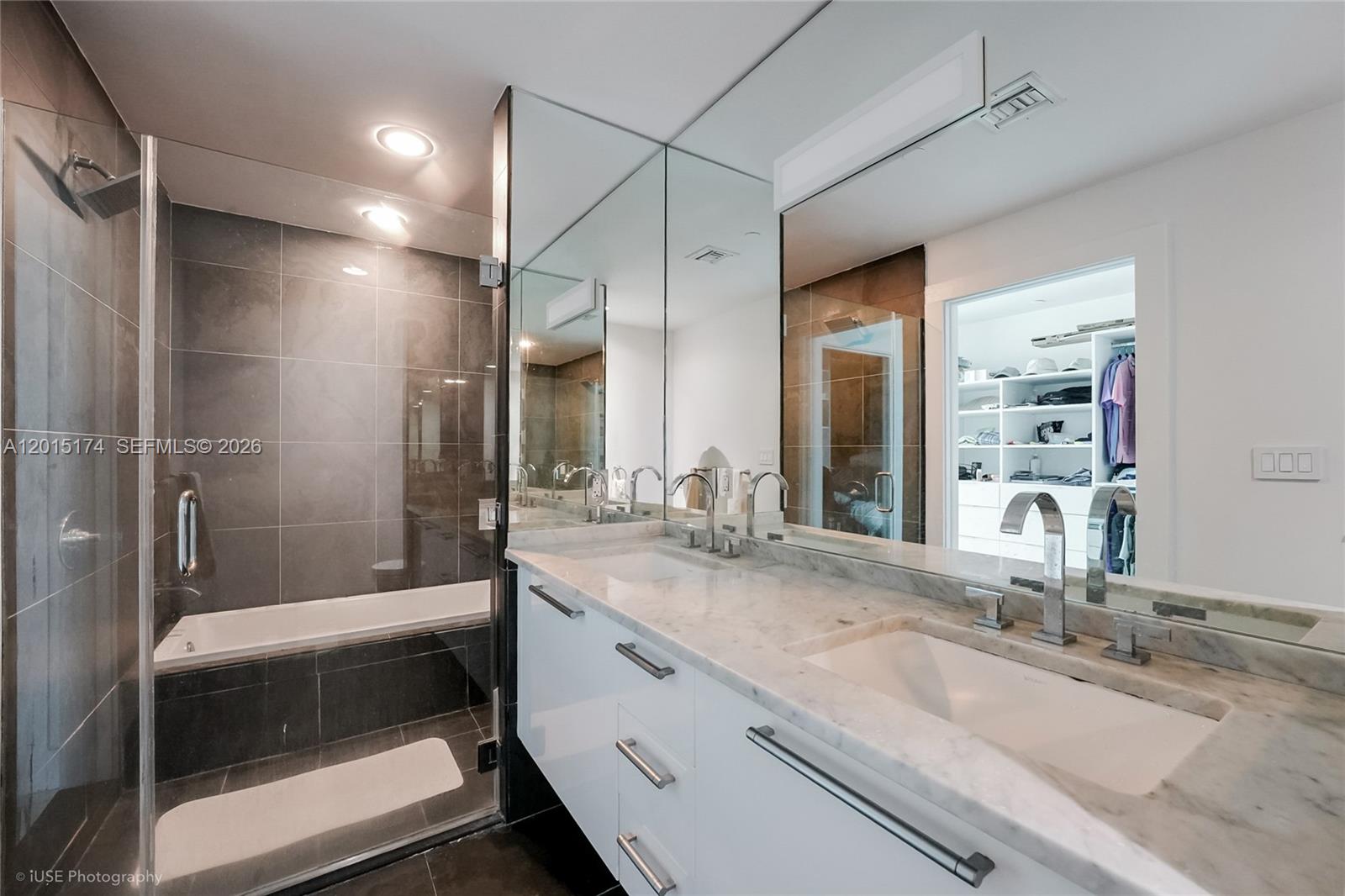 900 Biscayne Boulevard, Unit 3407 Miami, FL 33132 - Photo 10 of 15 a bathroom with double vanity and a shower