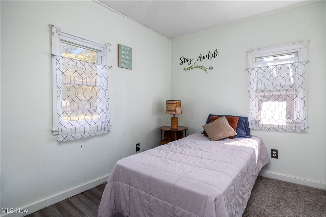 340 Erie Road Vermilion, OH 44089 - Photo 19 of 34 Bedroom with dark hardwood / wood-style floors and multiple windows