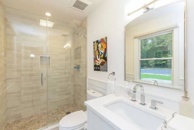 a bathroom with a sink toilet and shower
