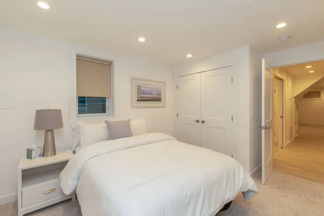 a bedroom with a bed and a lamp