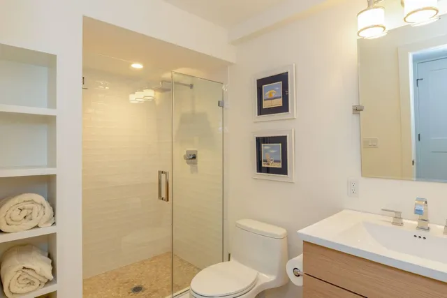 a bathroom with a sink toilet and shower