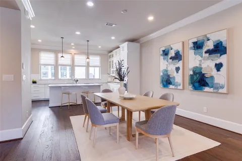 a large kitchen with dining table and chairs