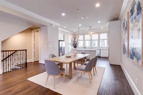a dining room with furniture and wooden floor
