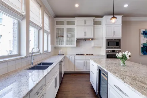a kitchen with granite countertop a sink and a stove