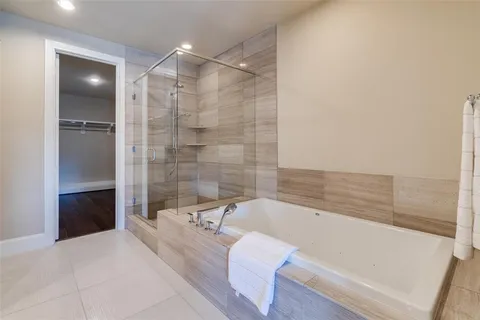 a bathroom with a bathtub and a shower