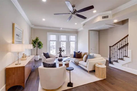 a living room with furniture and wooden floor