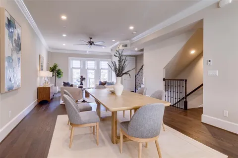 a dining room with furniture and wooden floor