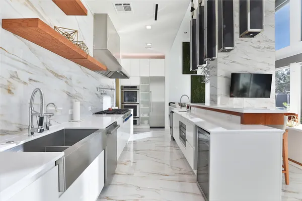 a kitchen with stainless steel appliances and white cabinets