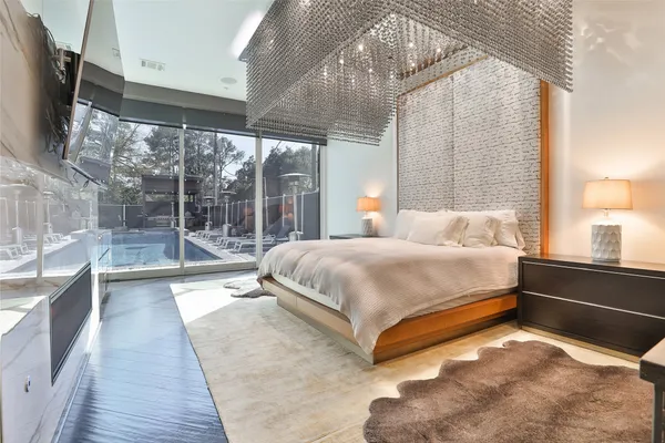 a bedroom with a bed and a flat screen tv