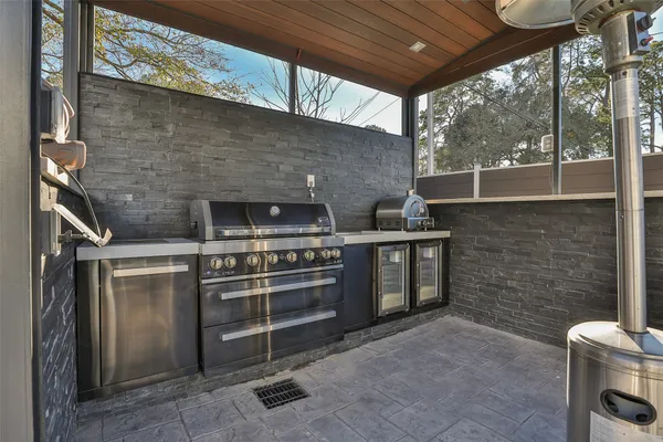a view of a backyard with table and chairs with wooden fence
