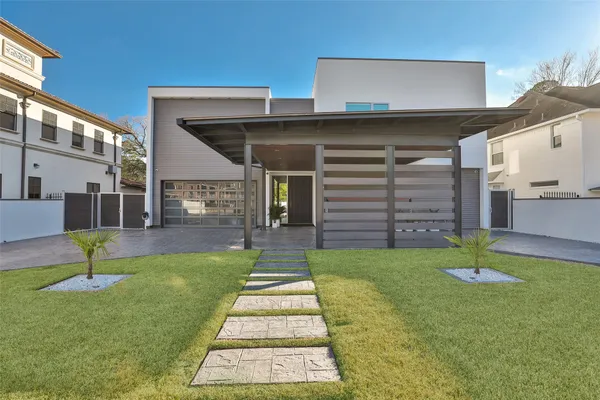 a view of a house with a yard and a garage