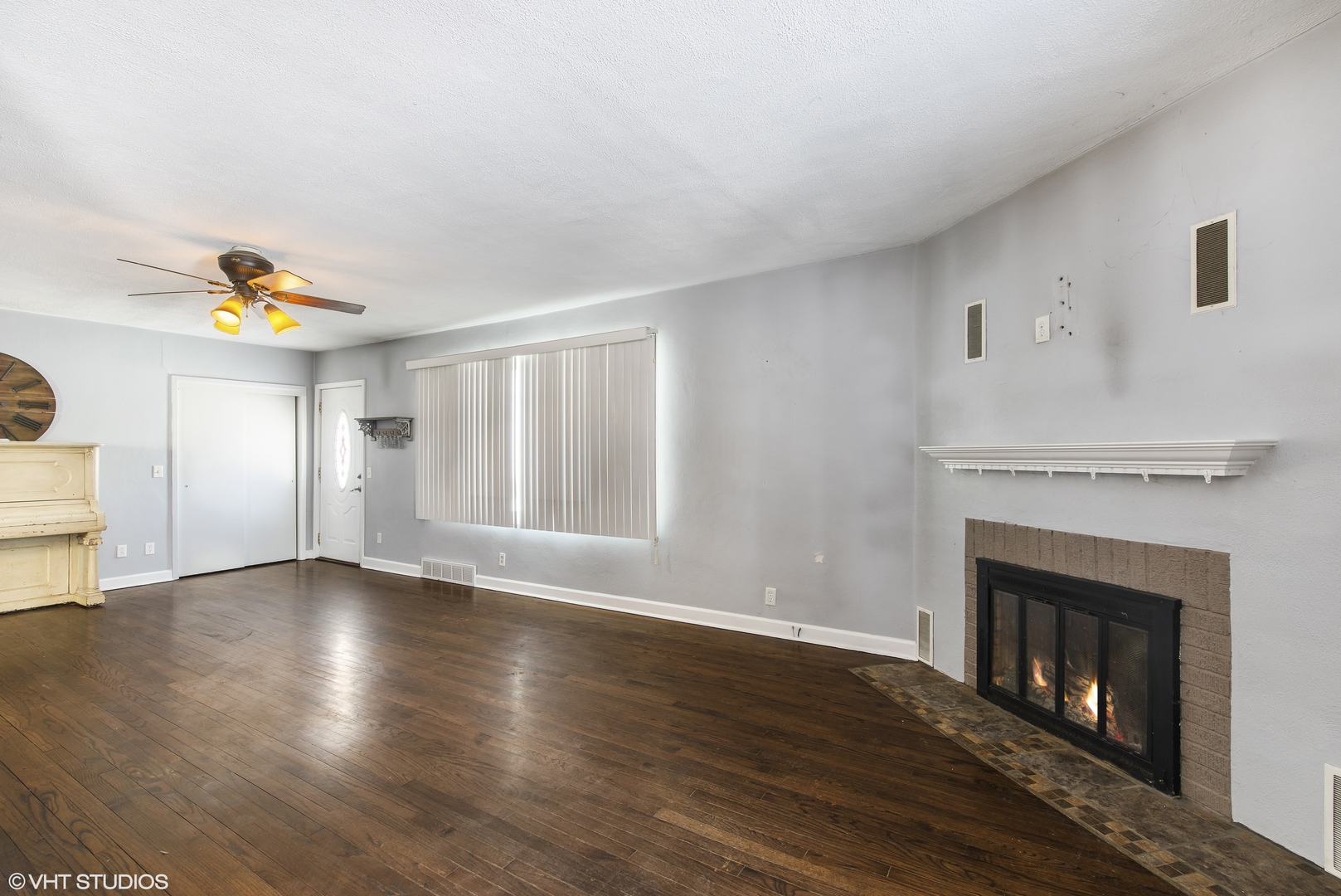 3559 Carlson Road Garden Prairie, IL 61038 - Photo 2 of 17 a view of an empty room with wooden floor and a fireplace