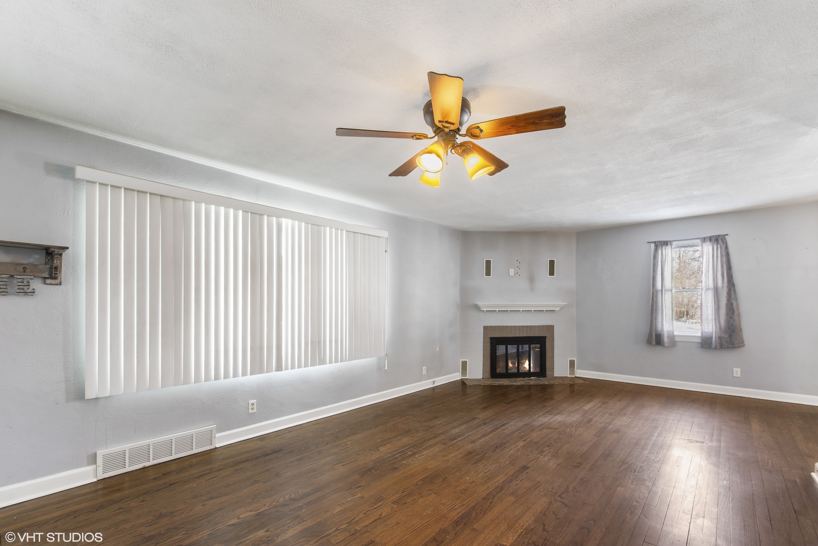 3559 Carlson Road Garden Prairie, IL 61038 - Photo 3 of 17 an empty room with wooden floor fireplace and windows