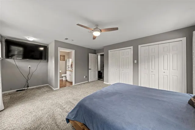 a bathroom with a granite countertop sink a toilet and a mirror