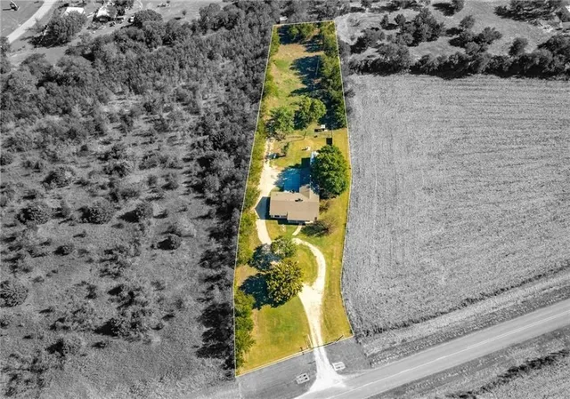 a aerial view of a residential houses with yard