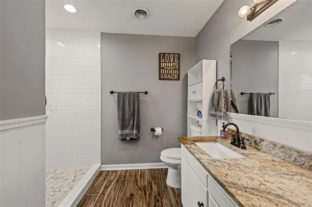 a bedroom with a bed and large windows