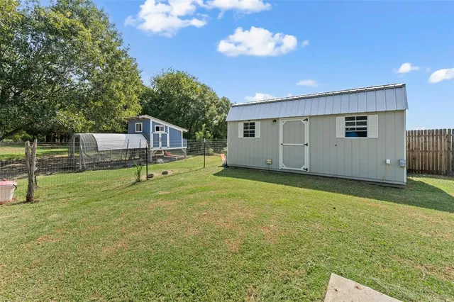a front view of a house with a yard table and chairs