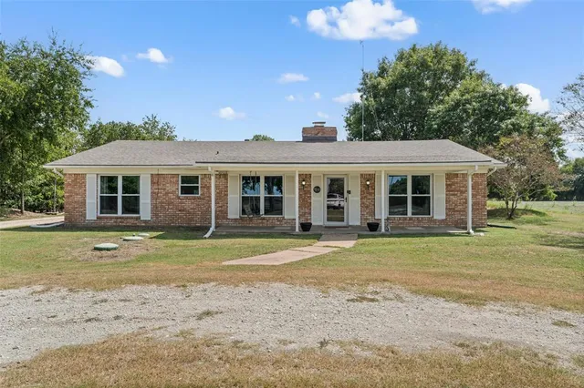 a view of an outdoor sitting area with brick walls