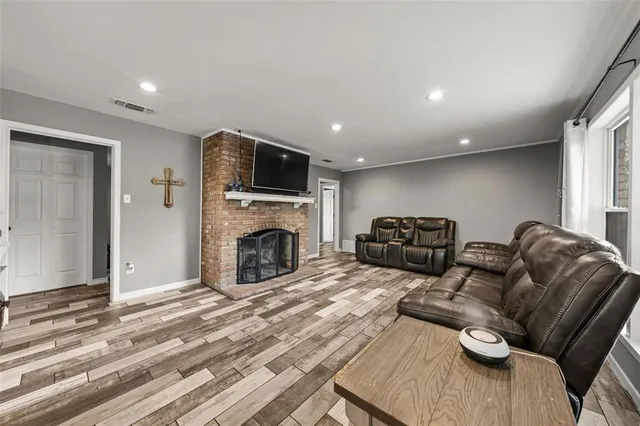 a kitchen with granite countertop a table chairs stove and refrigerator
