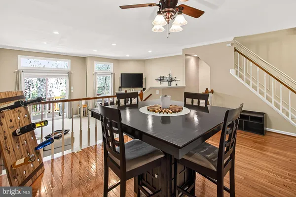 a view of a a dining room with furniture window and wooden floor