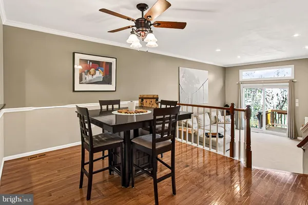 a living room with furniture and a ceiling fan
