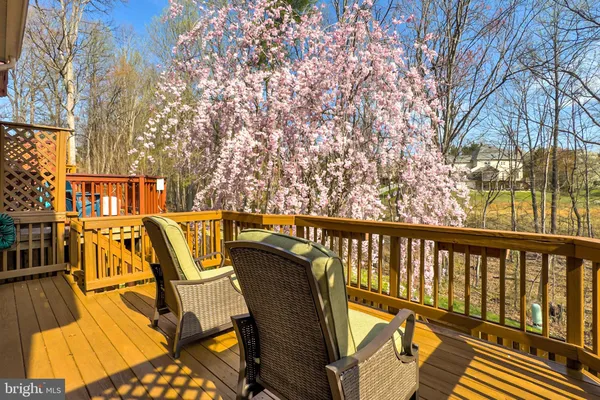 a view of balcony with wooden floor and outdoor seating