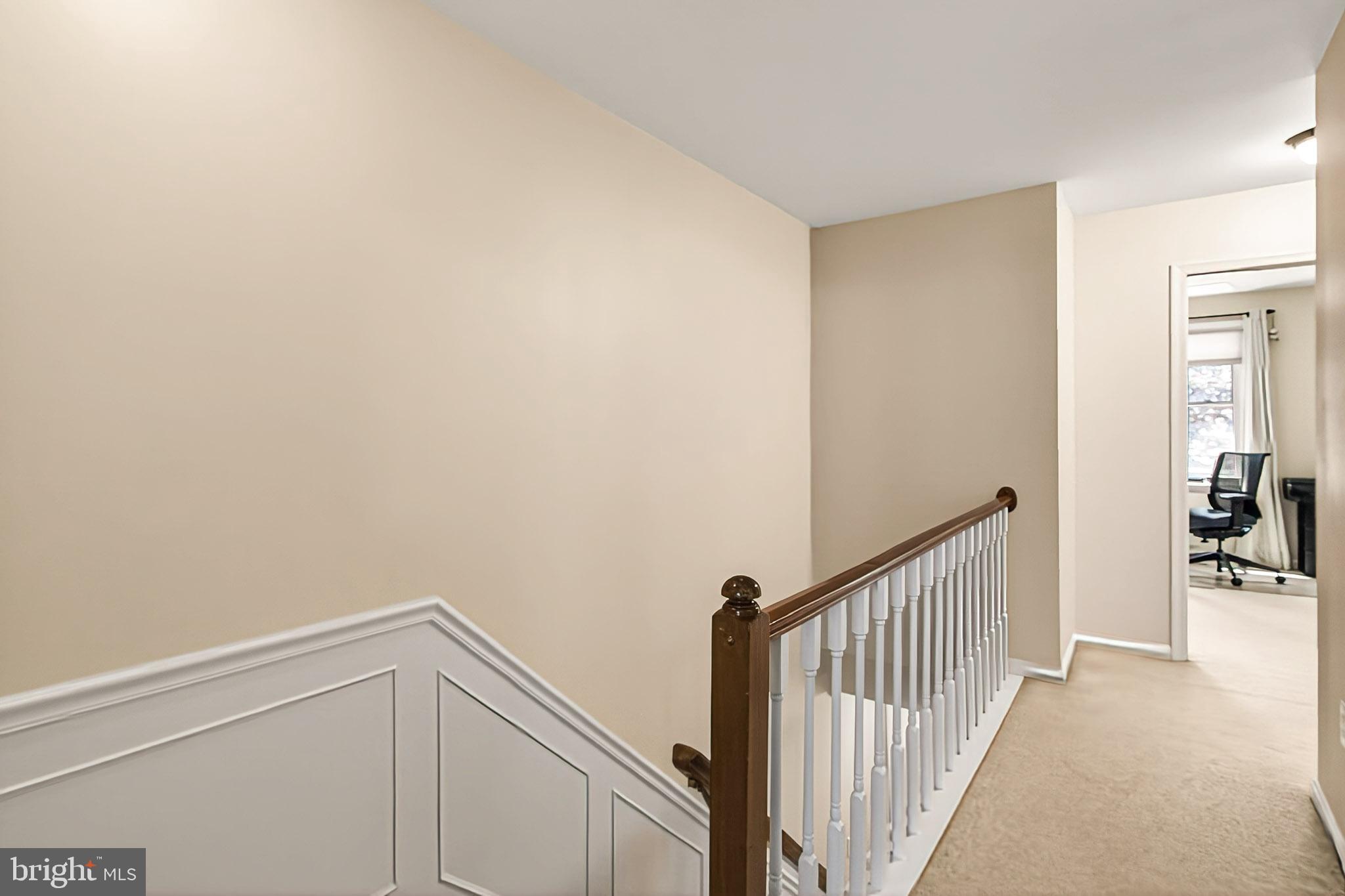 7923 Valleyfield Drive Springfield, VA 22153 - Photo 26 of 51 a view of a hallway with a white walls and wooden floor