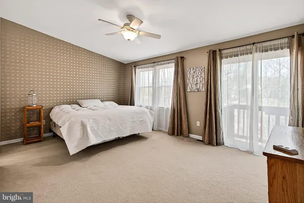 a spacious bedroom with a large bed and a large window