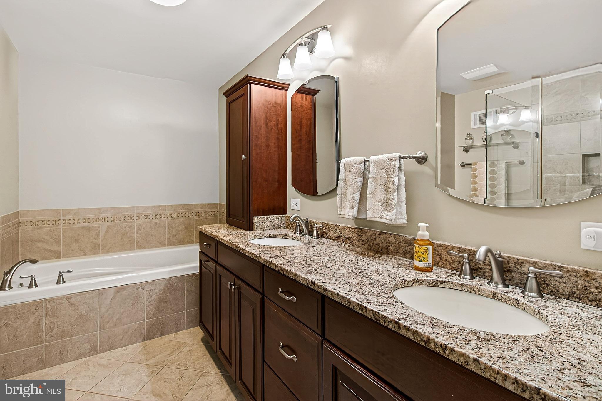 7923 Valleyfield Drive Springfield, VA 22153 - Photo 31 of 51 a bathroom with a granite countertop double vanity sink and a large mirror