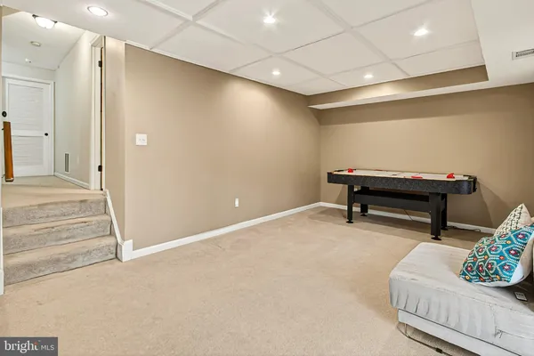 a living room with furniture toys and a window