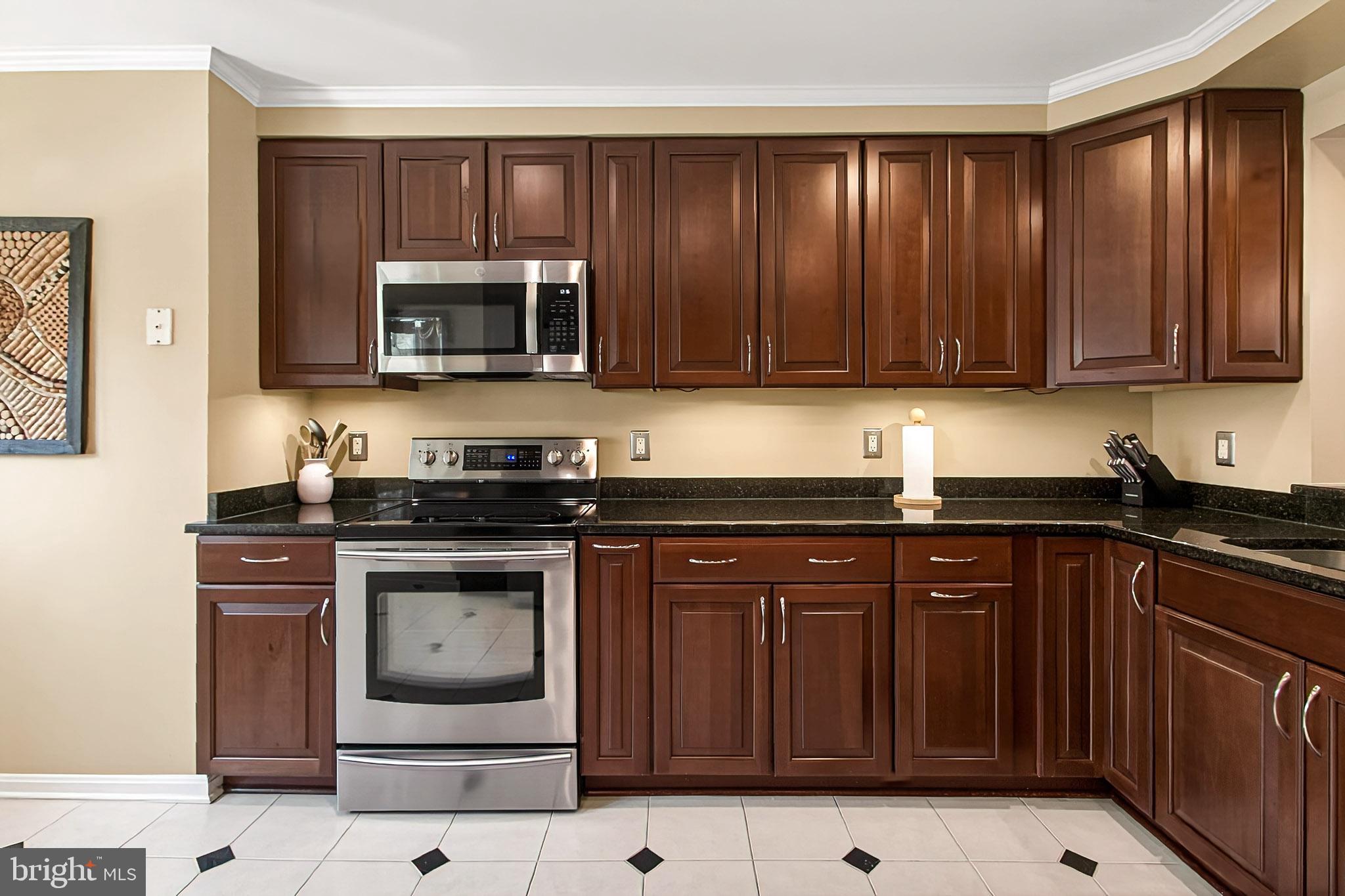 7923 Valleyfield Drive Springfield, VA 22153 - Photo 7 of 51 a kitchen with wooden cabinets and stainless steel appliances