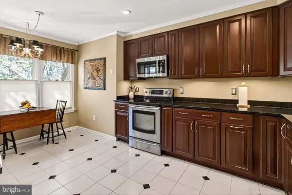 a dining room with a window wooden floor and a fireplace