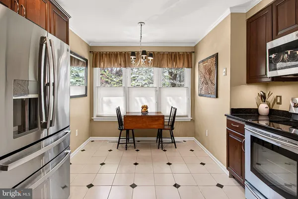 a kitchen with stainless steel appliances a stove top oven