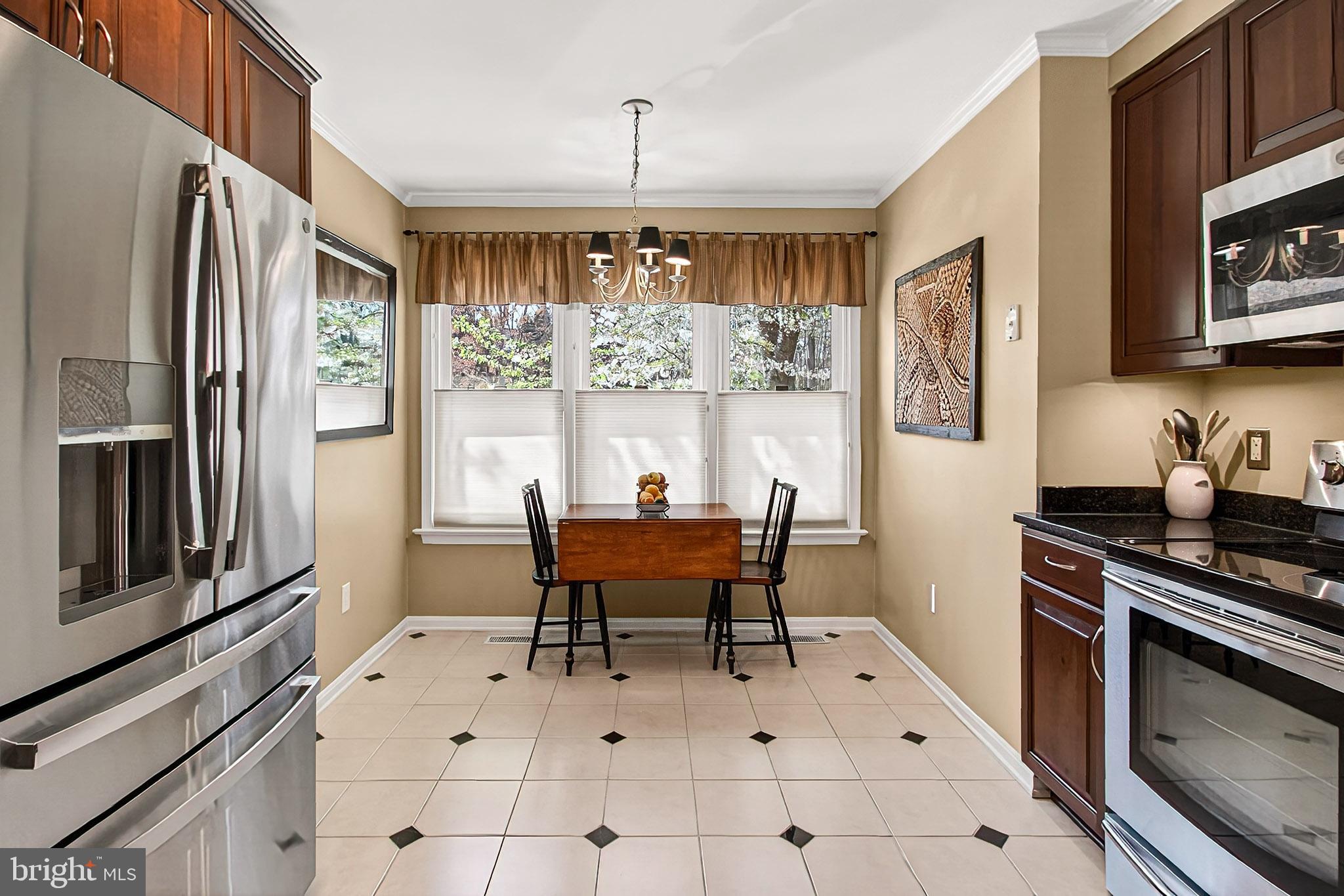 7923 Valleyfield Drive Springfield, VA 22153 - Photo 9 of 51 a dining room with a window wooden floor and a fireplace