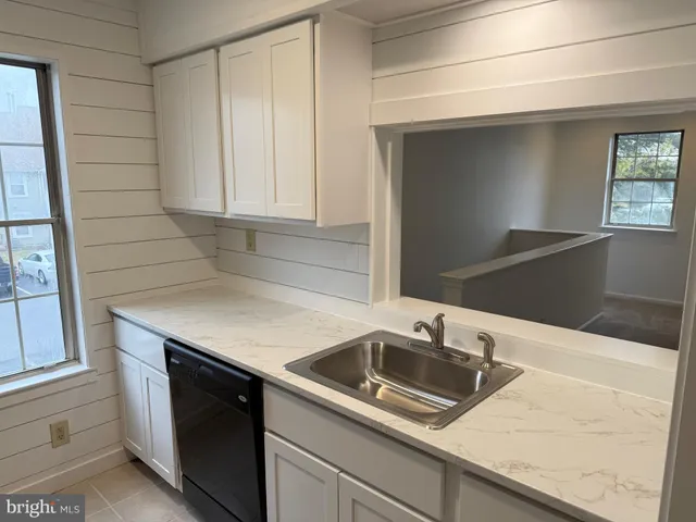 a kitchen with granite countertop a sink and a stove