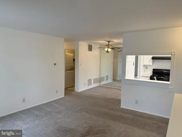 an empty room with a fireplace and windows