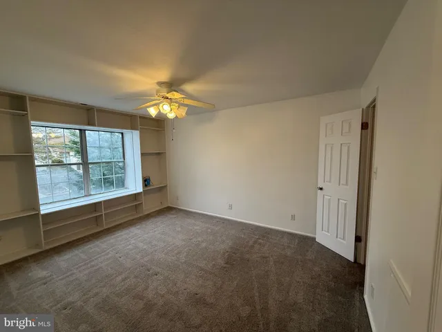 an empty room with a empty space and a large window