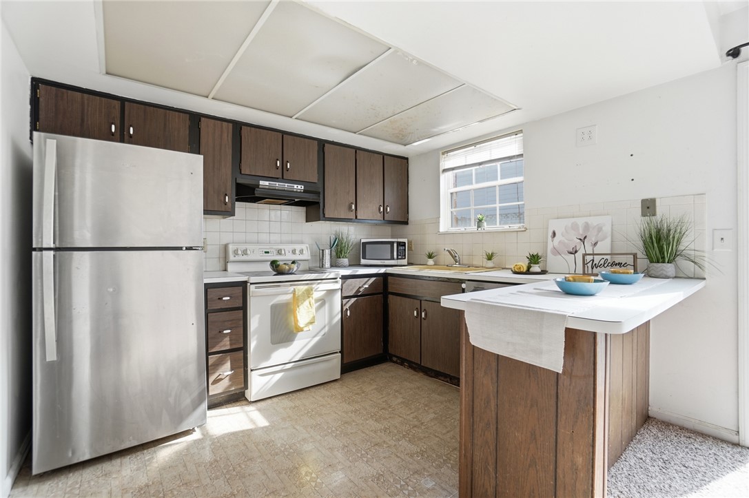5414 Lamme Road Dayton, OH 45439 - Photo 15 of 32 This bright kitchen features ample counter space and appliances, perfect for daily meals.