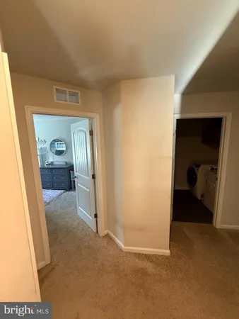 a bedroom with furniture and a air conditioner vent