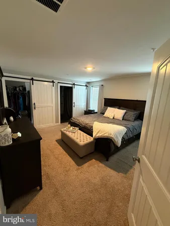 a bedroom with a bed and dresser