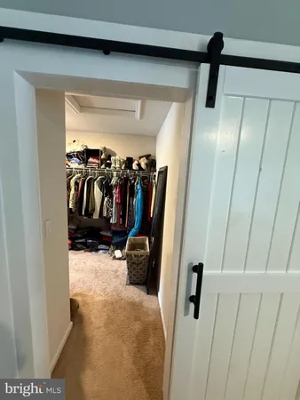 a bedroom with furniture and a book shelf