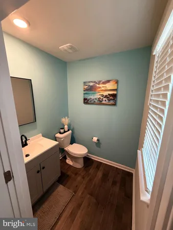 a kitchen with stainless steel appliances a table chairs microwave and refrigerator