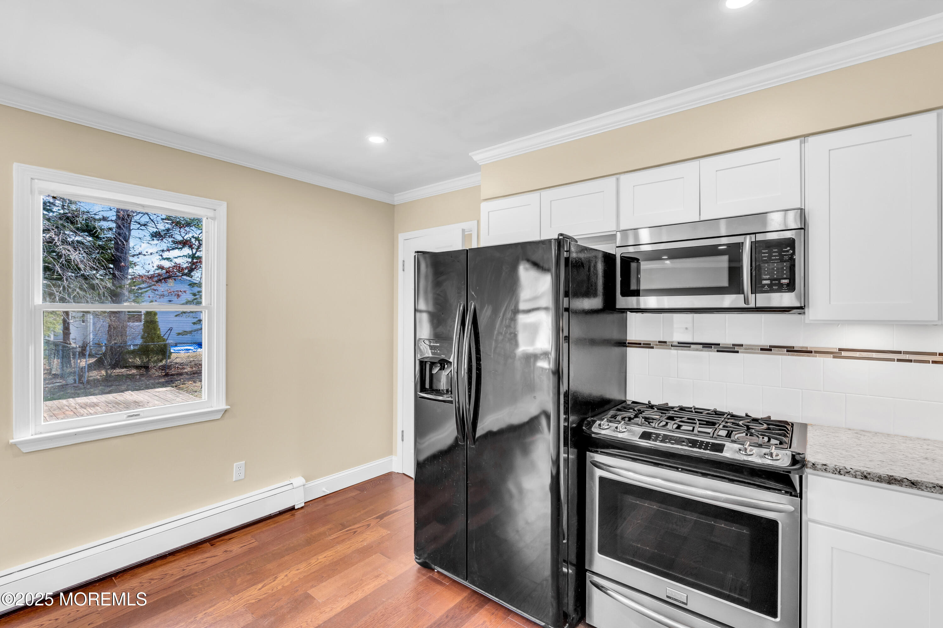 1612 Beverly Road Forked River, NJ 08731 - Photo 11 of 38 a kitchen with stainless steel appliances a stove a microwave and a hard wood floor