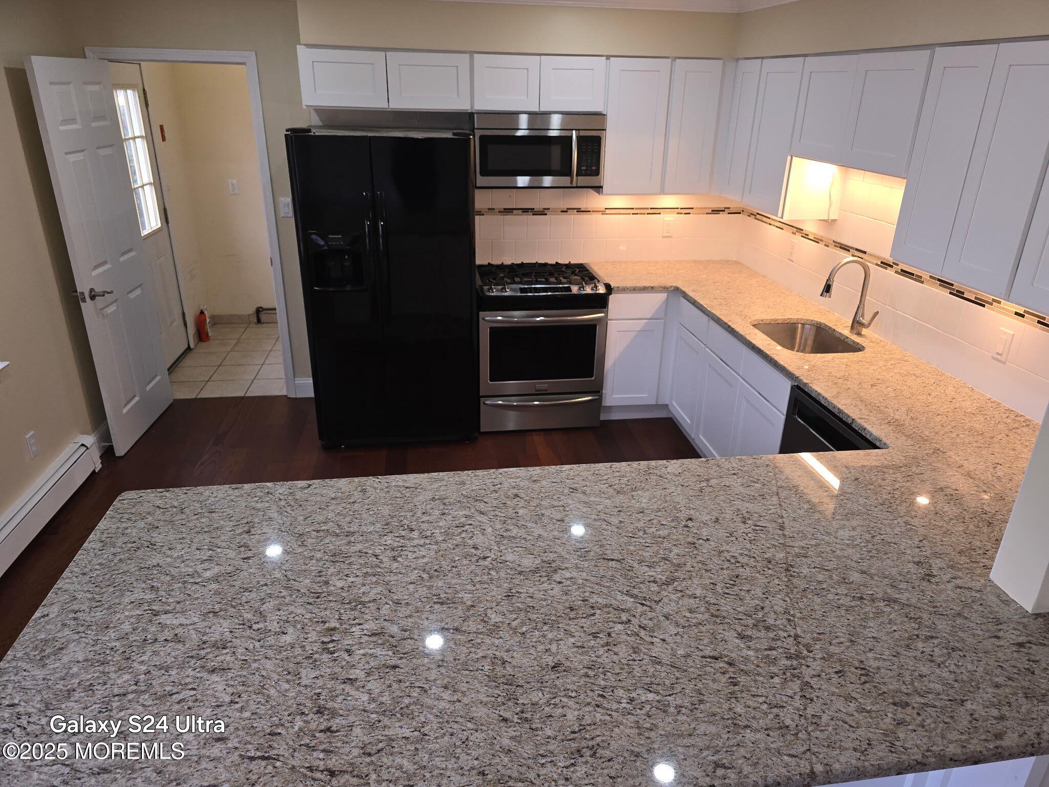 1612 Beverly Road Forked River, NJ 08731 - Photo 12 of 38 a kitchen with stainless steel appliances granite countertop a refrigerator a stove and a sink with wooden cabinets