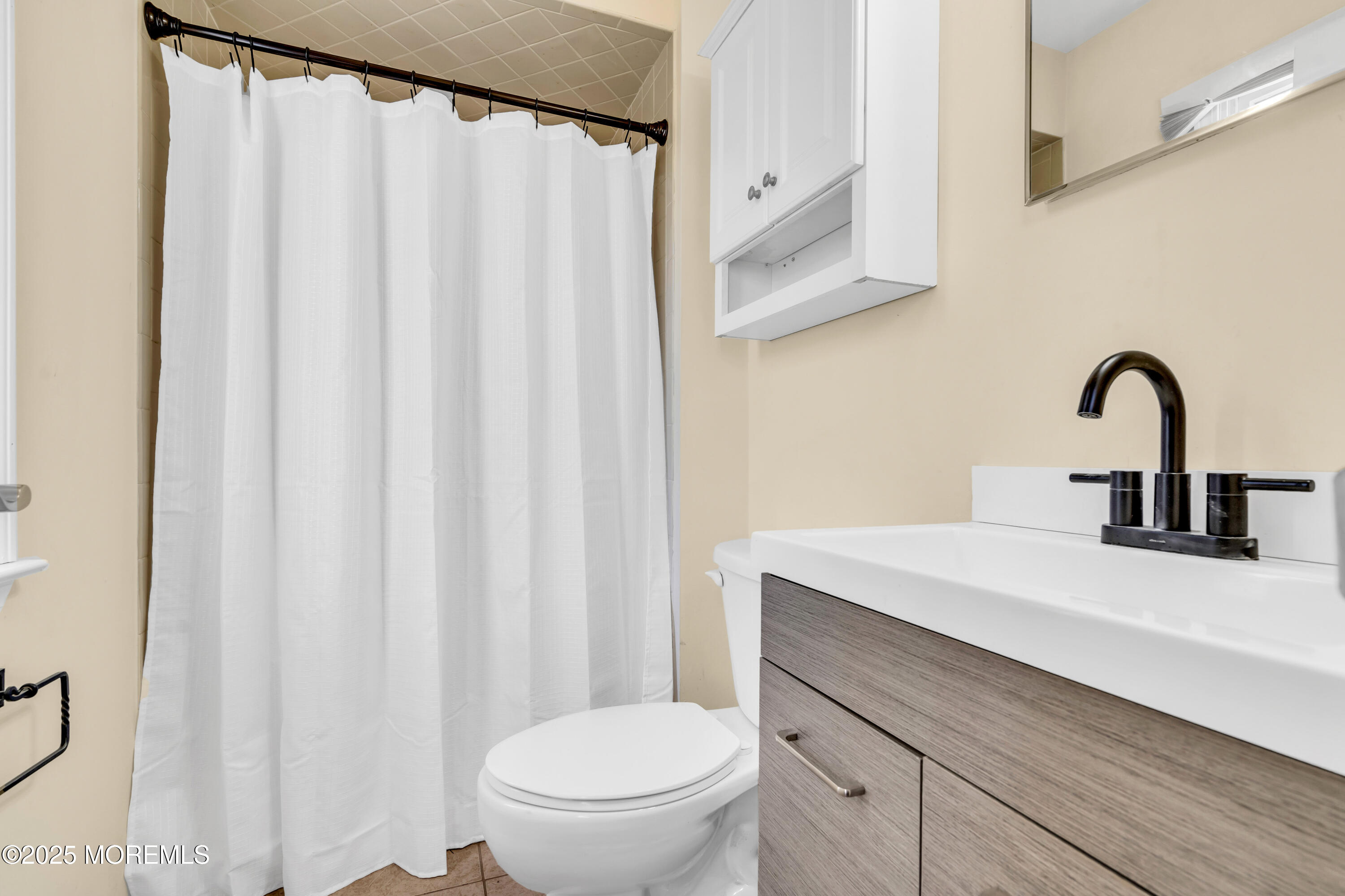 1612 Beverly Road Forked River, NJ 08731 - Photo 17 of 38 a bathroom with a sink a toilet and a mirror