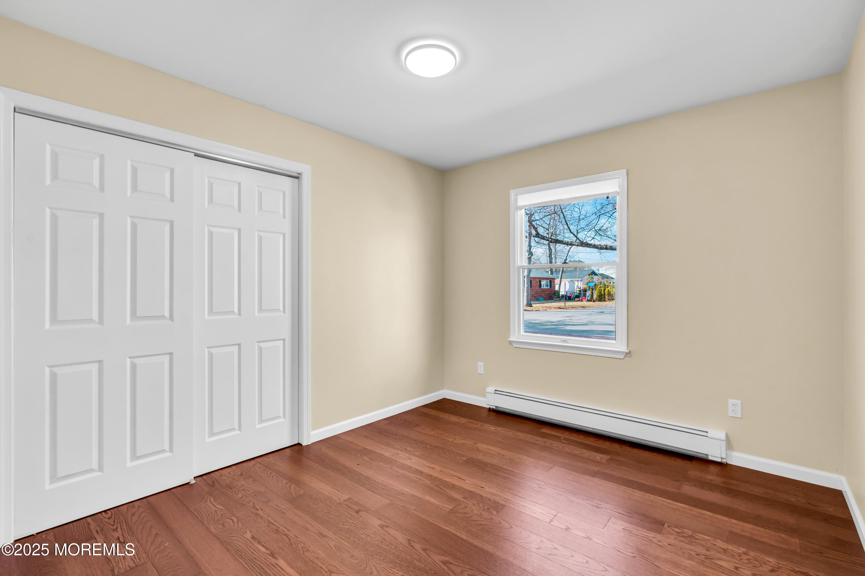 1612 Beverly Road Forked River, NJ 08731 - Photo 20 of 38 an empty room with wooden floor and window