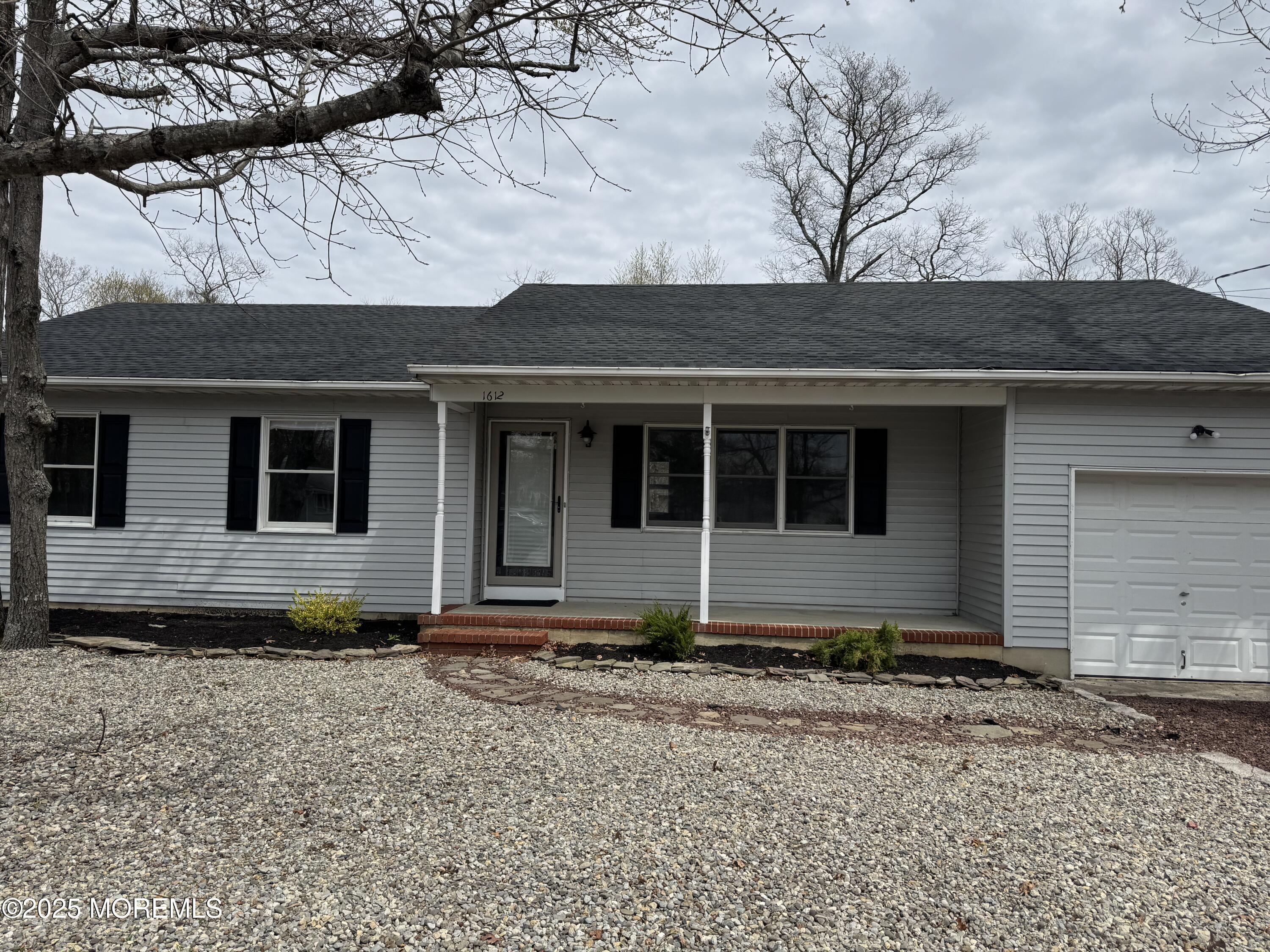1612 Beverly Road Forked River, NJ 08731 - Photo 3 of 38 a front view of a house with a garden