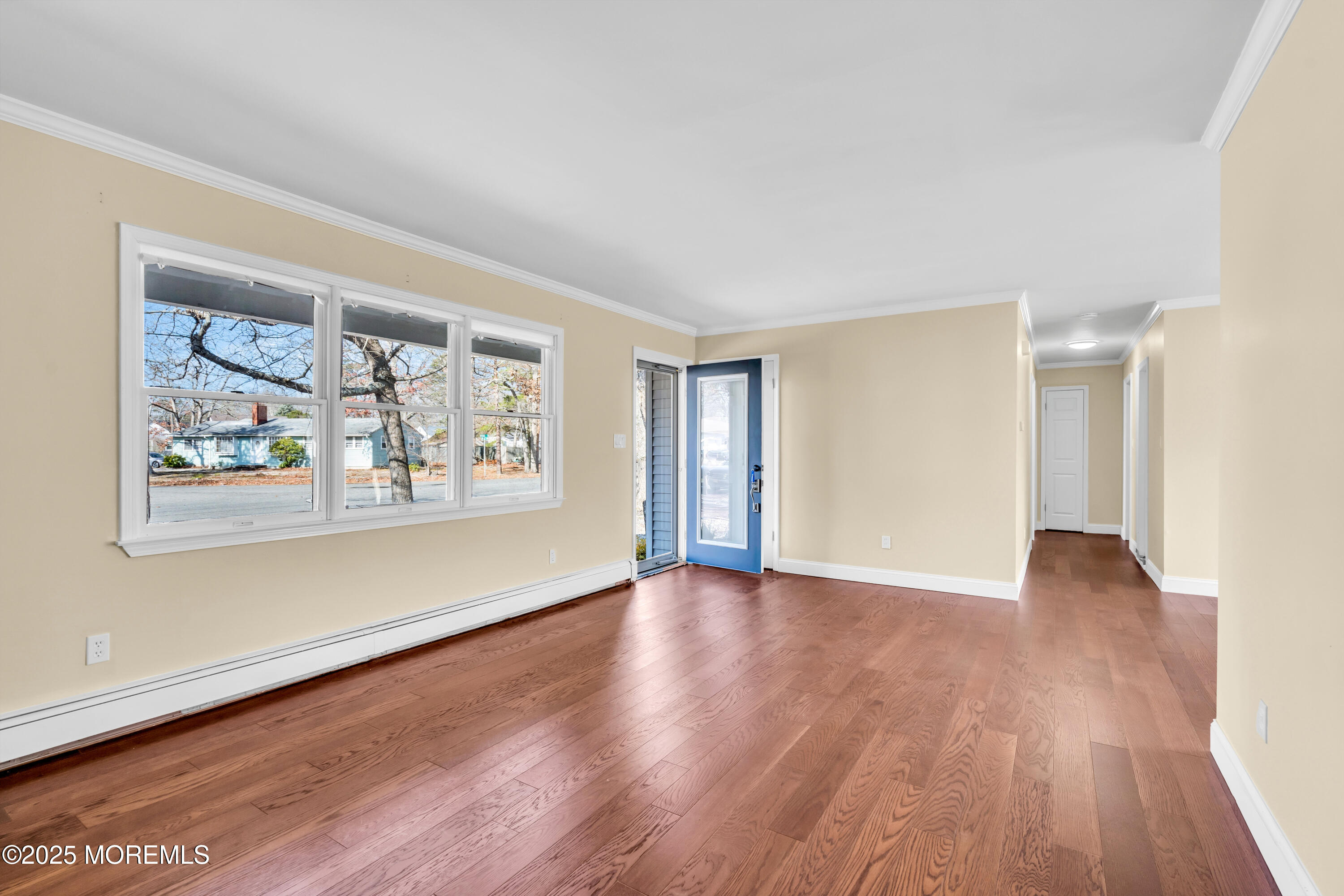 1612 Beverly Road Forked River, NJ 08731 - Photo 6 of 38 a view of an empty room with wooden floor and a window