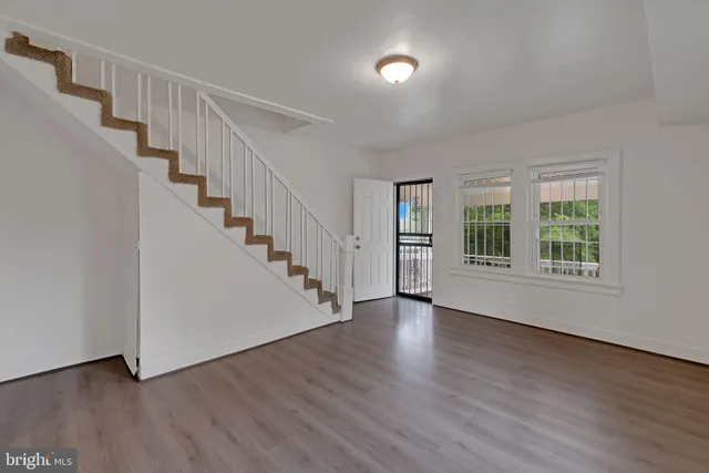 wooden floor in an empty room with a window